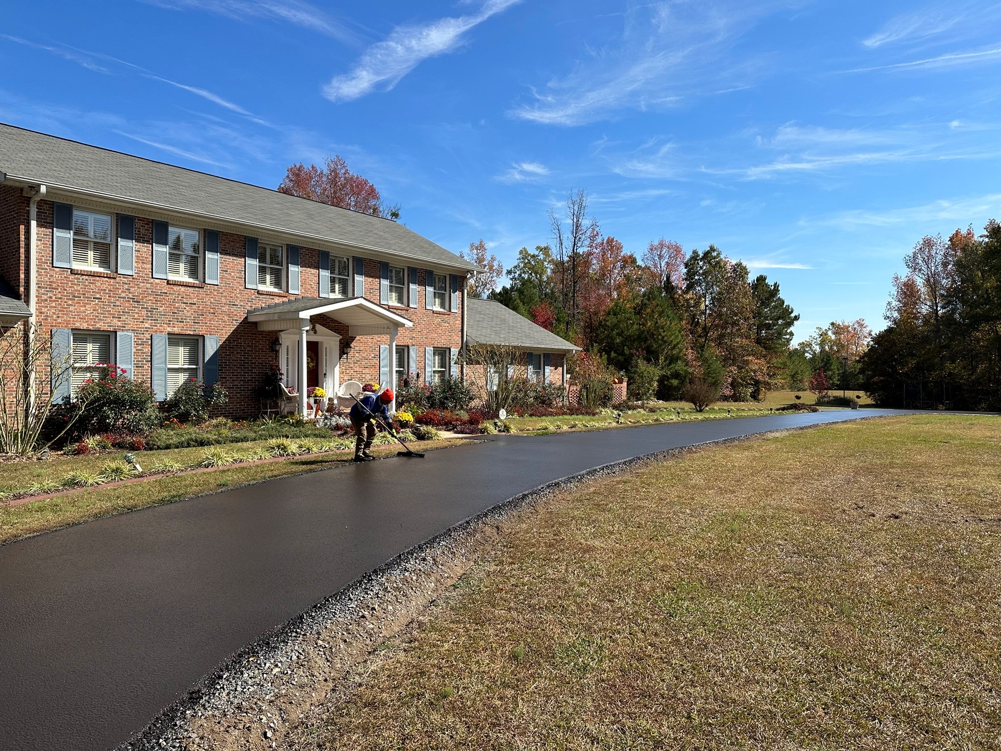 Fresh sealcoating on a residential blacktop driveway